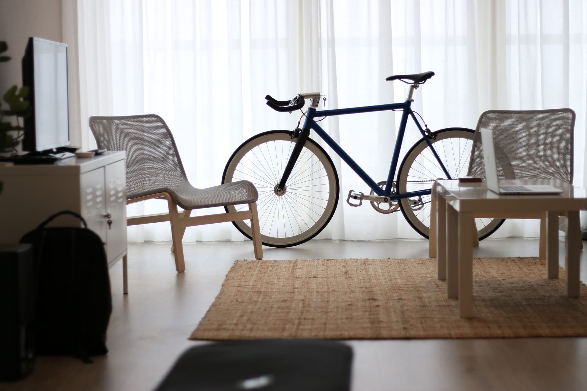 A complete indoor cycling pain cave with trainer, fan, mat and a large screen